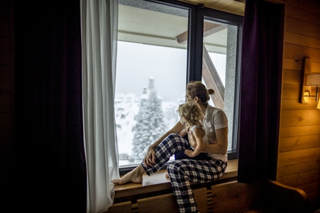 mother and child watching snow fall