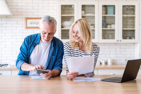 couple happily computing bills
